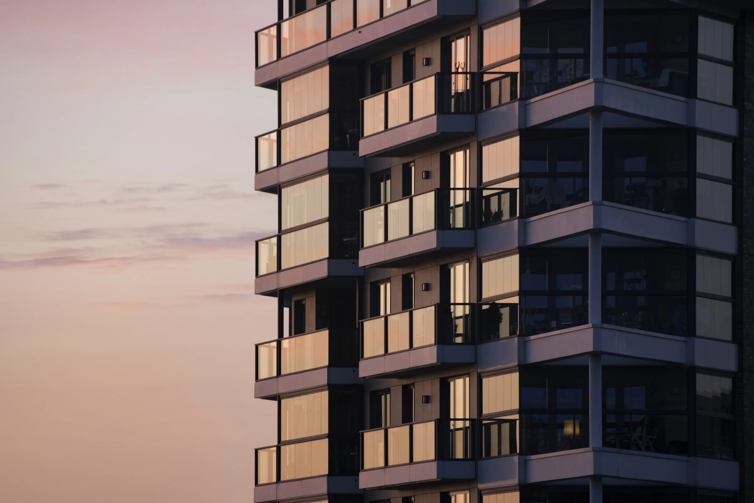 Modern apartment community exterior representing 24/7 AI leasing agent coverage for property management