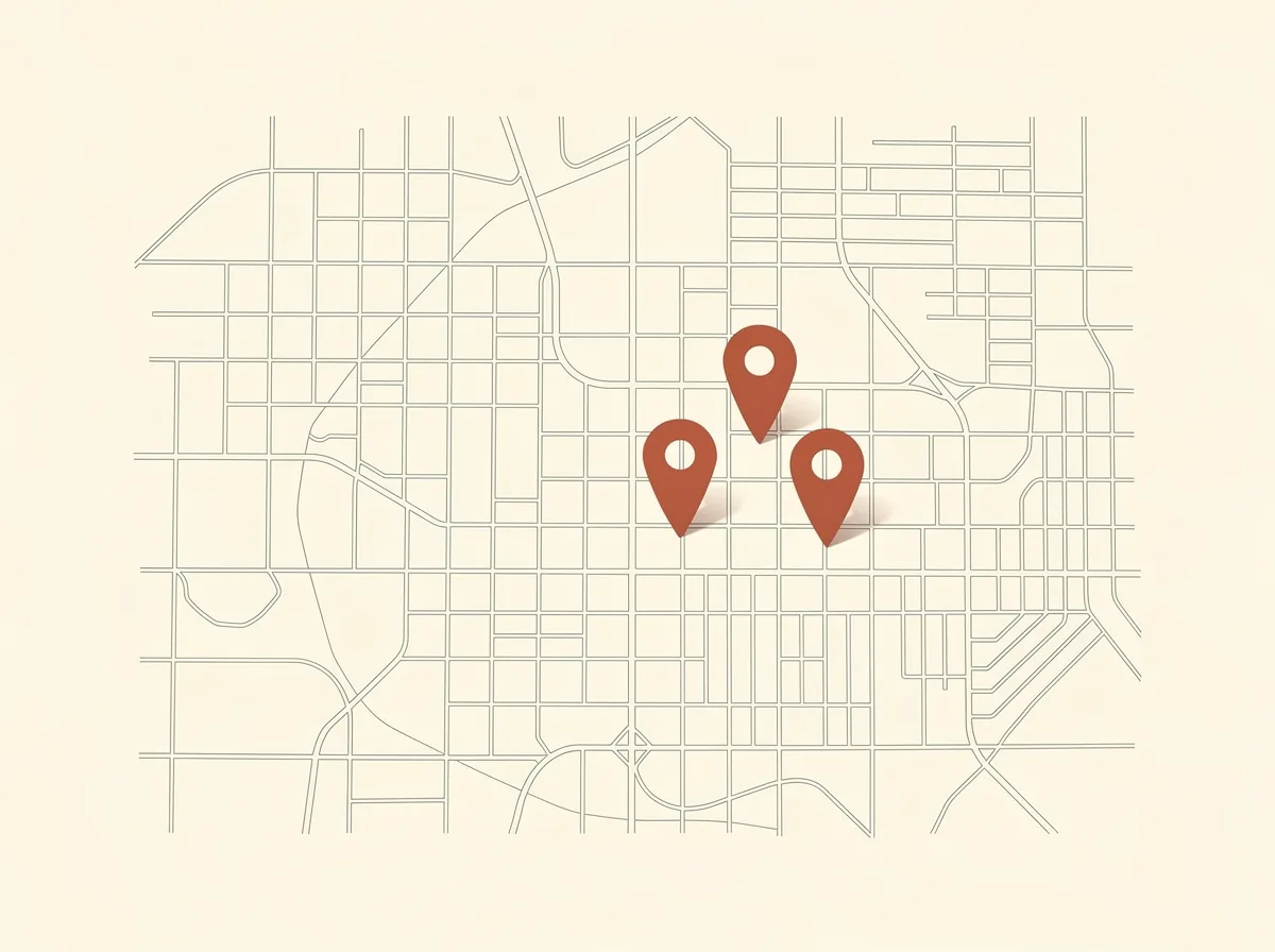 Minimal map grid showing three terracotta location pins marking a roofing company service area